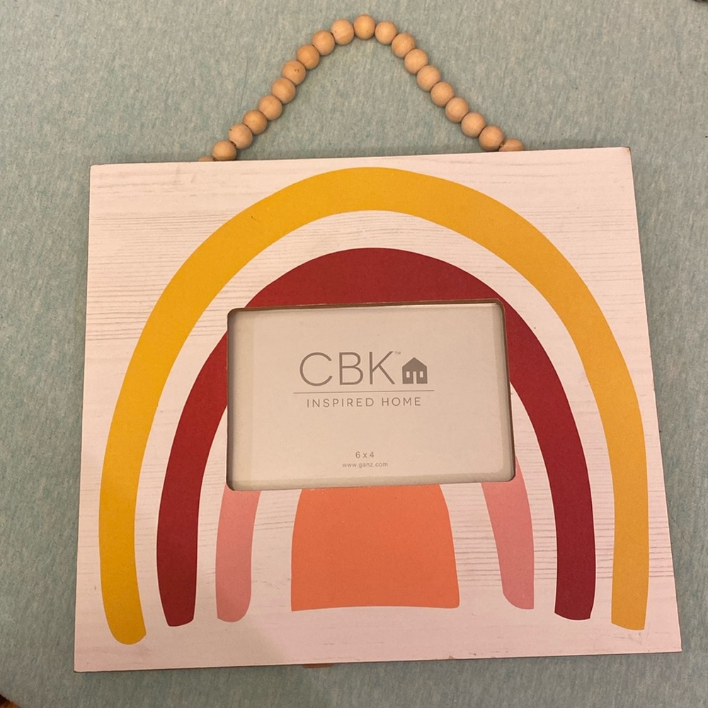 Decorative picture frame boutique bought never used. Hangs by beads/stand